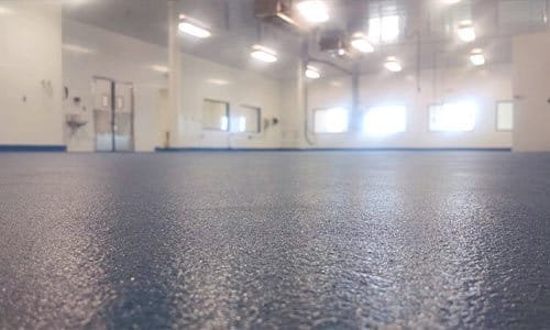 Glossy industrial warehouse floor with anti-slip coating